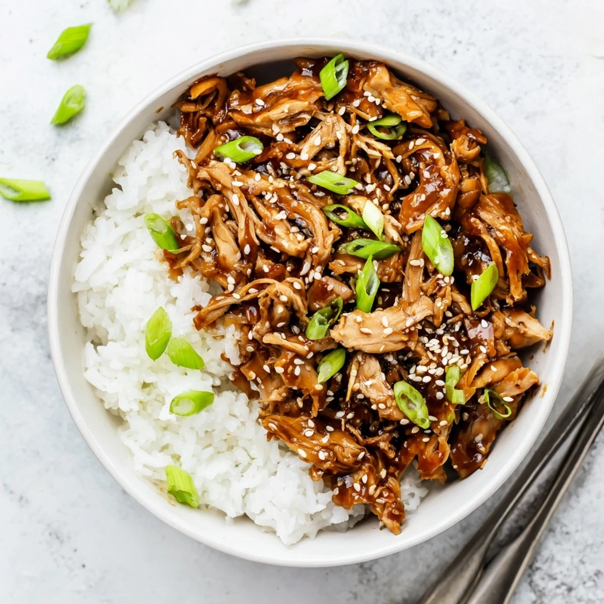 Tender chicken pieces simmering in homemade savory teriyaki sauce inside a slow cooker