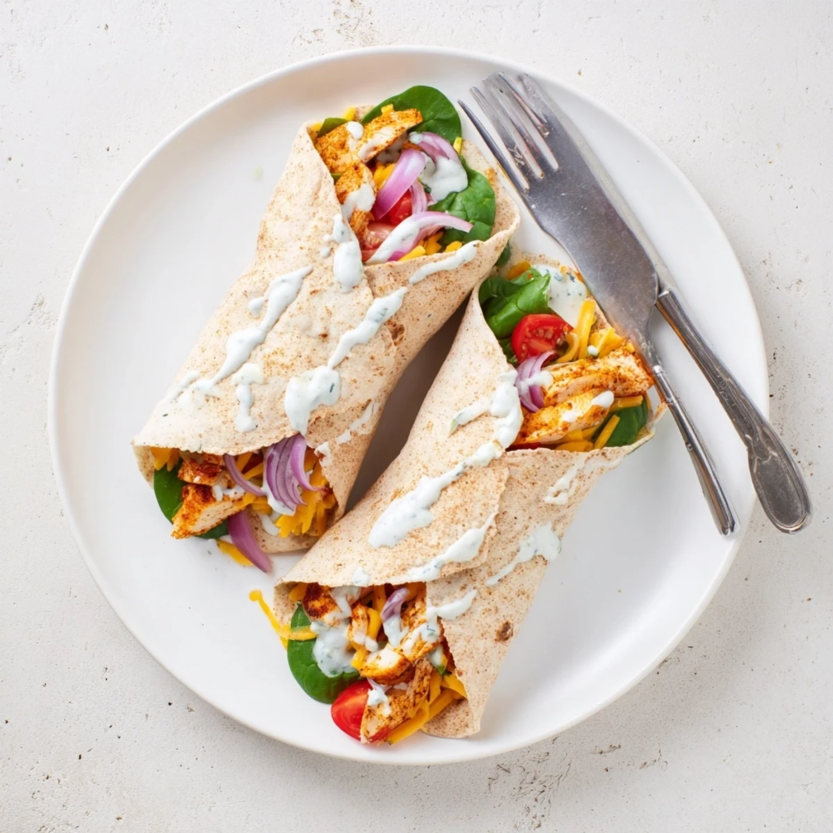 Crispy grilled low carb cheesy garlic chicken wraps served with garlic yogurt sauce