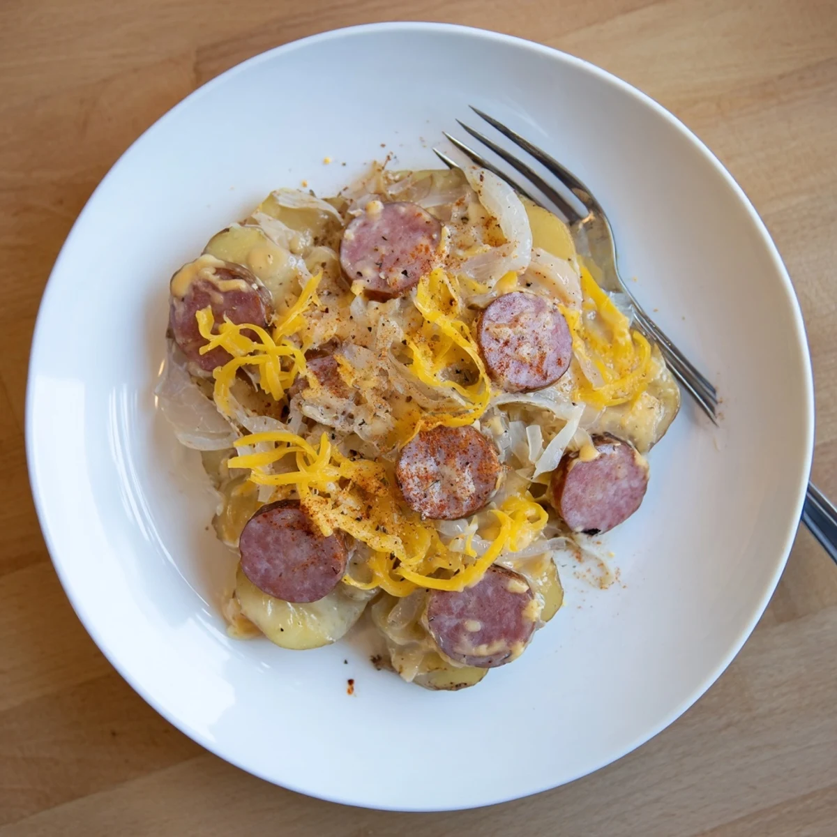 Hearty slow cooker scalloped potatoes kielbasa featuring tender potato layers and melted cheddar topping