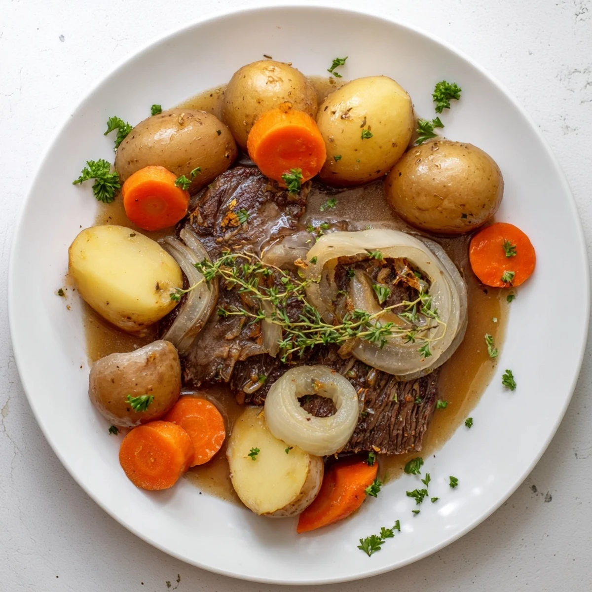 Hearty slow cooker steak and potatoes featuring seared beef nestled among tender vegetables