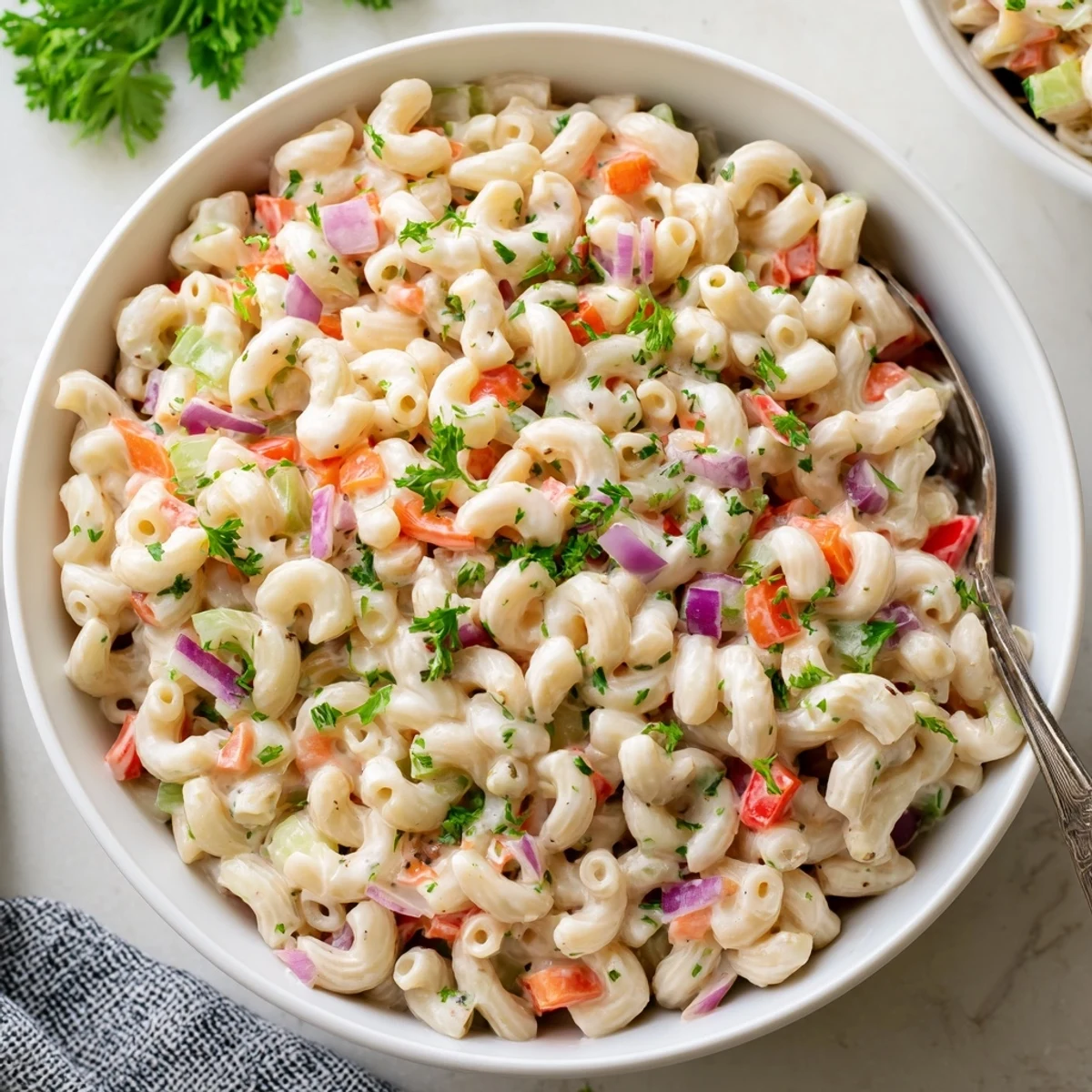 Tangy and creamy macaroni salad featuring tender pasta and crunchy red bell pepper pieces