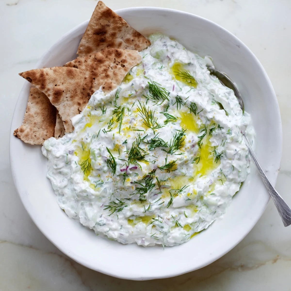 Close-up of healthy radish tzatziki dip garnished with herbs and drizzled with olive oil
