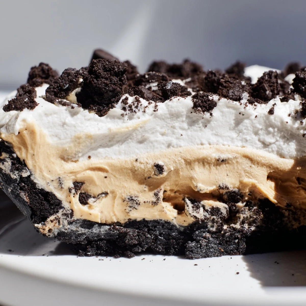 Rich peanut butter Oreo pie in a dark chocolate cookie crust ready to serve
