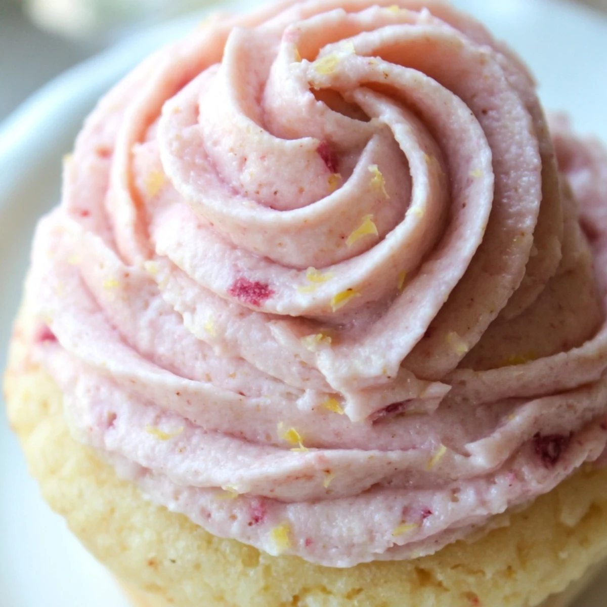 Fresh strawberry lemonade cupcakes topped with swirled lemon buttercream and berry garnish