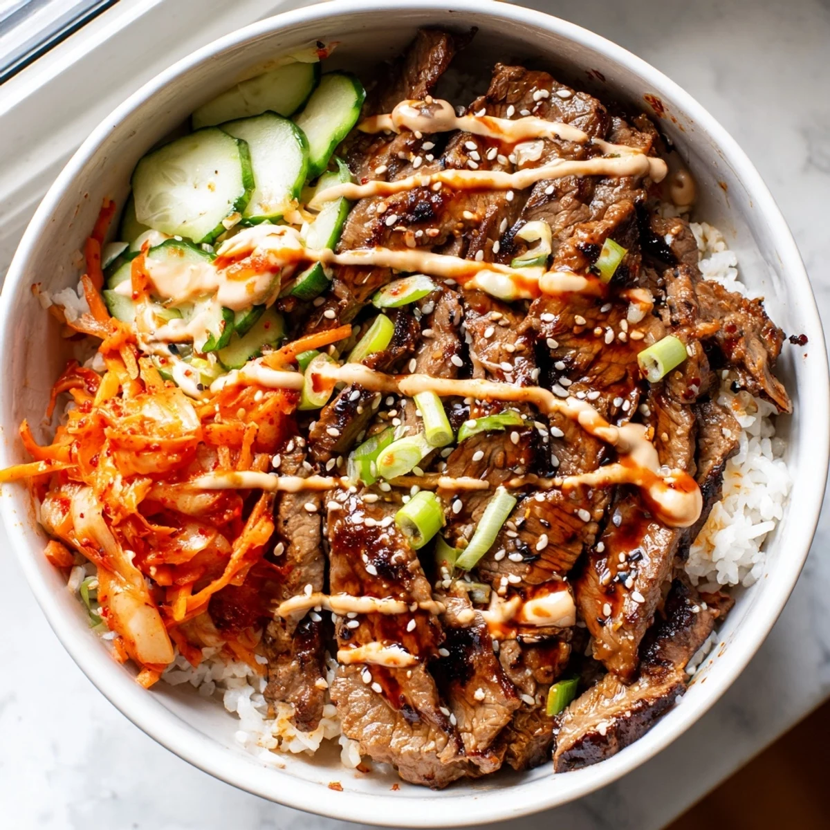 Caramelized Korean BBQ steak rice bowls drizzled with spicy cream sauce over fluffy rice