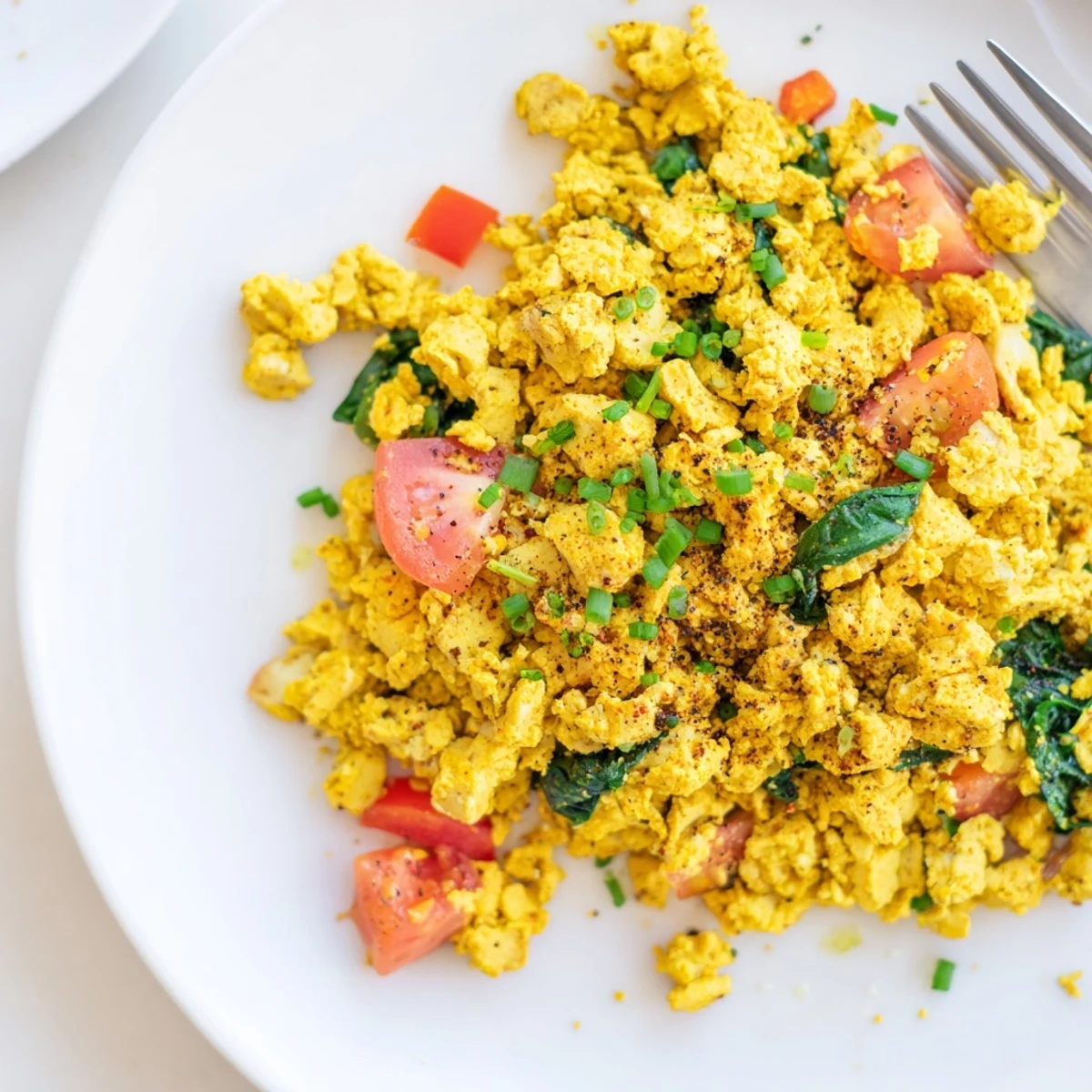 Bright Tofu Scramble studded with red pepper, tomato, warm cumin aroma