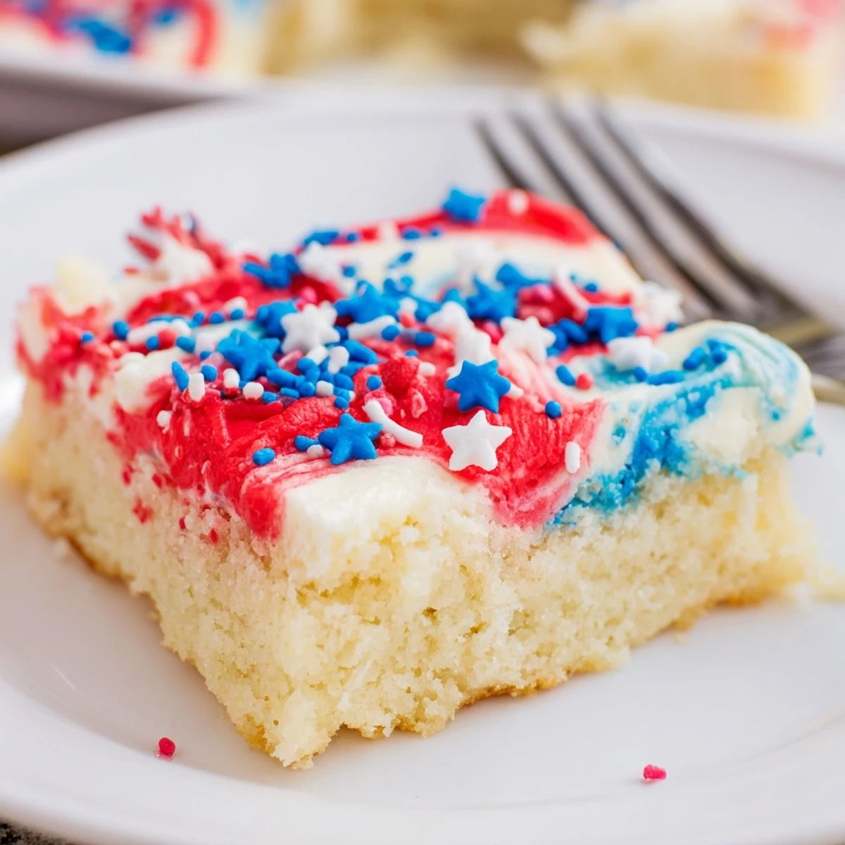 Plated Patriotic Sugar Cookie Bars dusted with sprinkles, buttery aroma promising summer.  