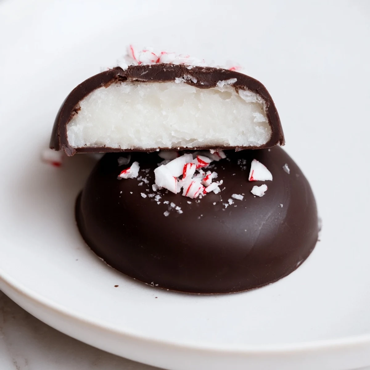 Plate of Peppermint Patties beside a steaming mug of cocoa, inviting