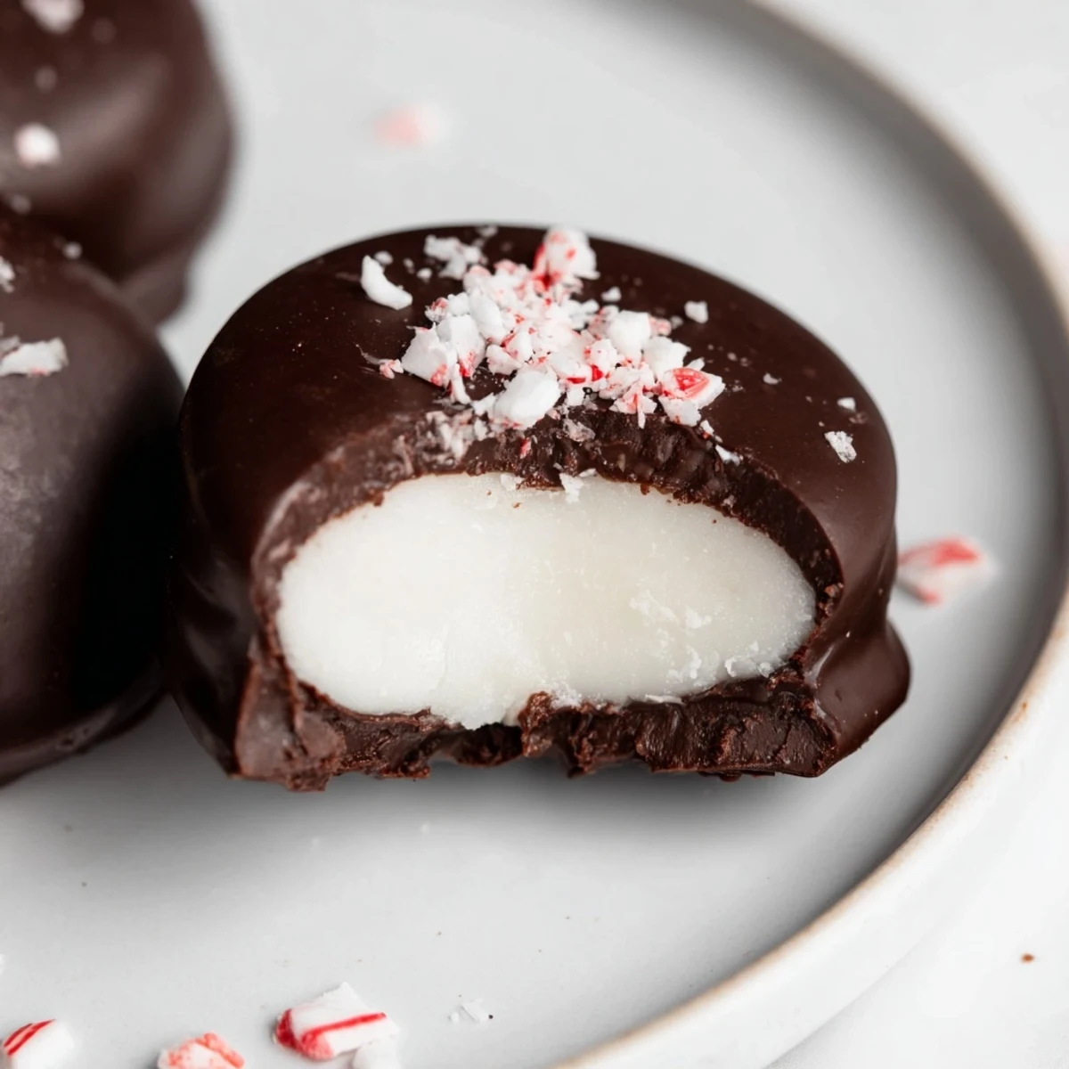 Homemade Peppermint Patties chilled, fork dipped glossy coating, sprinkled with crushed candy