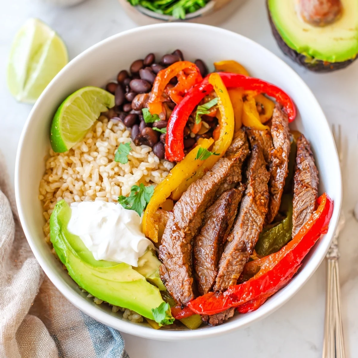 Steak Fajita Power Bowls with sizzling marinated steak, peppers, creamy avocado  