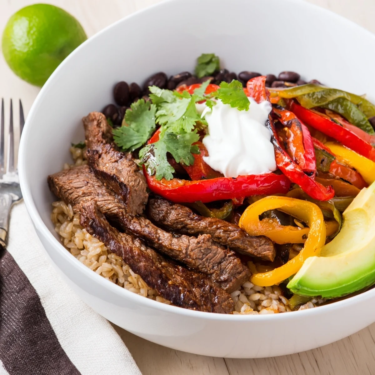 Hearty Steak Fajita Power Bowls served hot with cilantro, tangy Greek yogurt