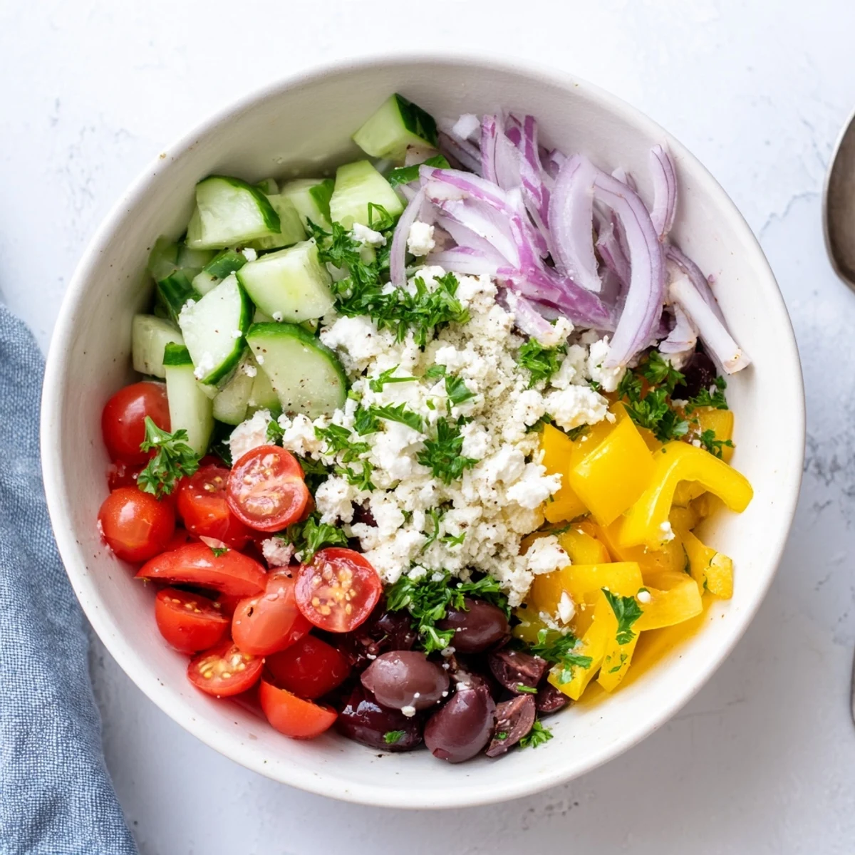 Protein-packed Greek salad cottage cheese bowl featuring crisp cucumbers, tomatoes, and Kalamata olives