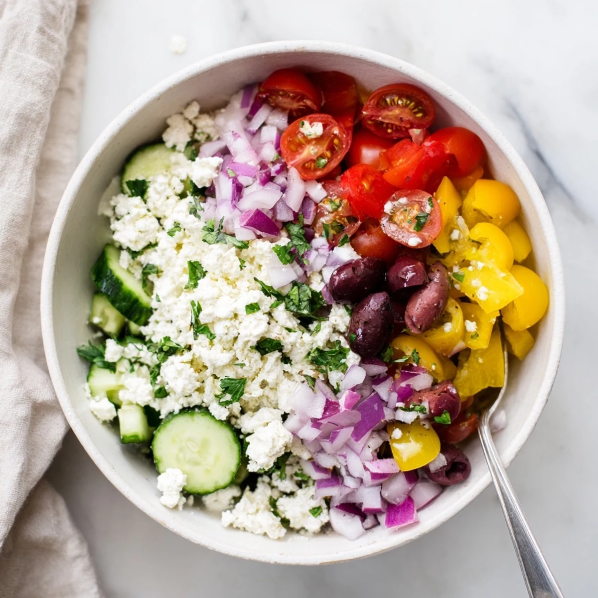 Wholesome Greek salad cottage cheese bowl arranged with colorful vegetables and tangy feta cheese garnish