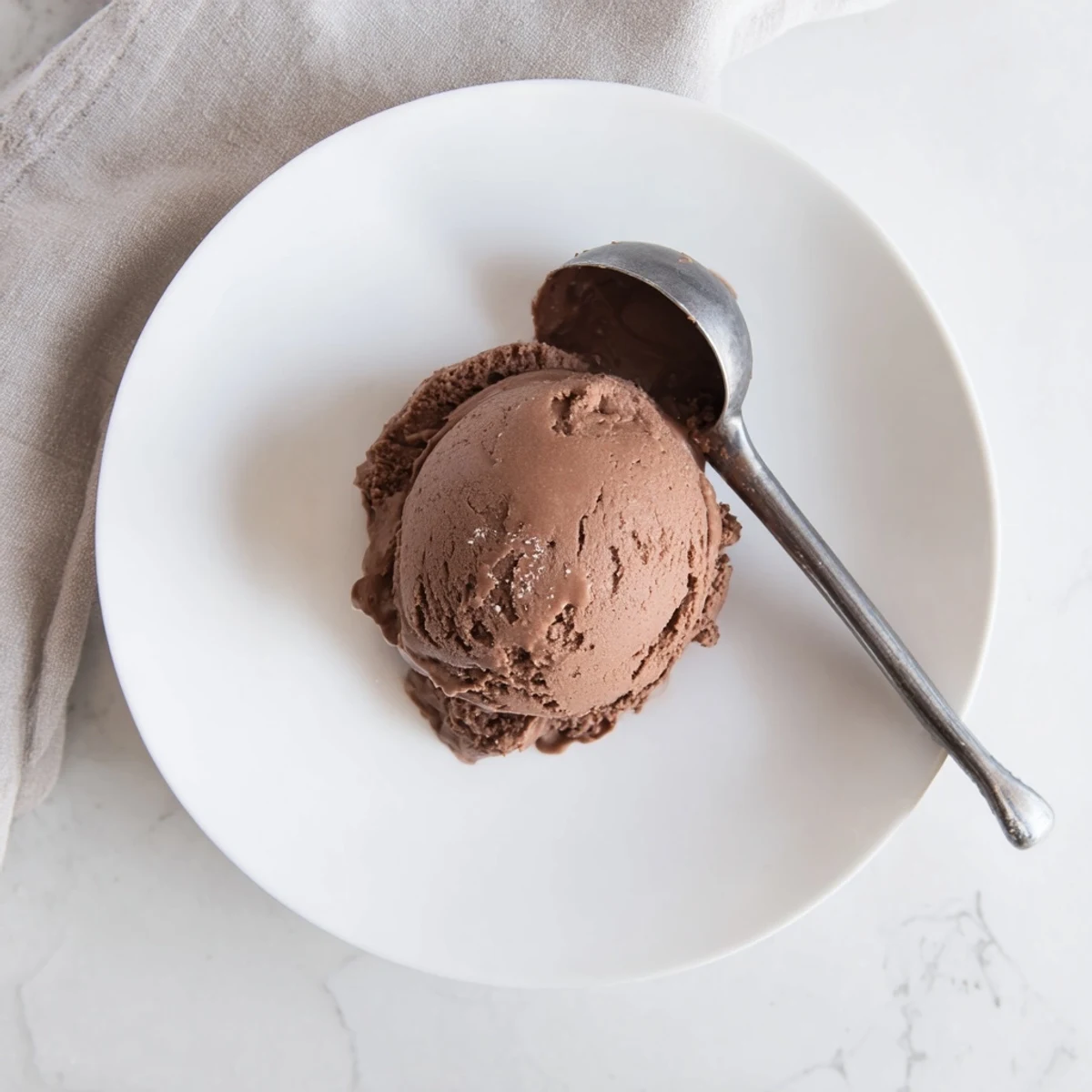 Creamy chocolate sourdough ice cream scooped into a chilled glass bowl with dark chocolate shavings