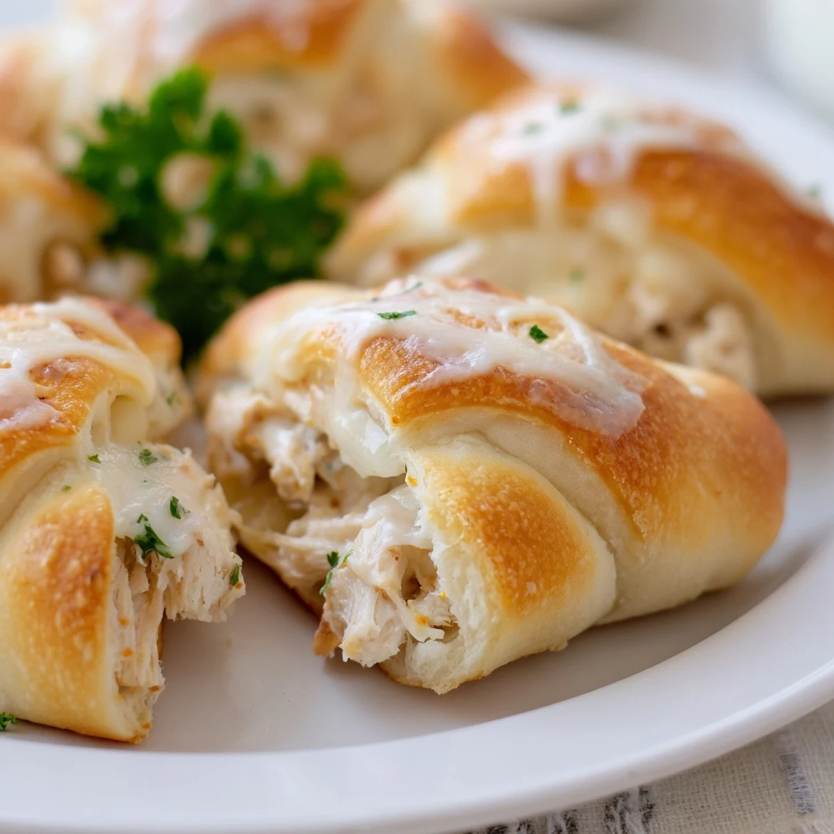 Tender chicken and cream cheese filling baked inside buttery pastry pillows served with rich white parmesan sauce