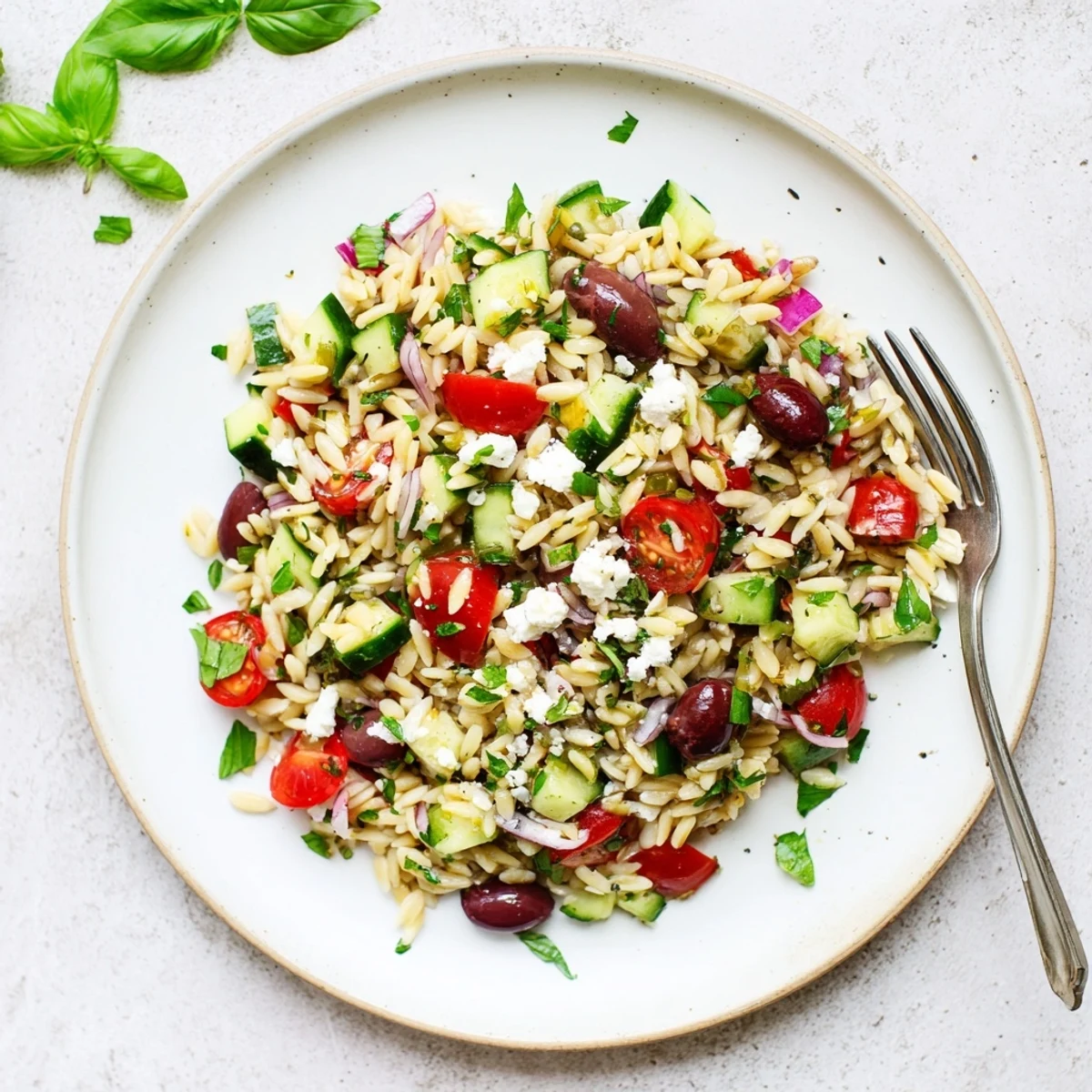 Mediterranean Orzo Pasta Salad tossed with fresh herbs, cucumber, and a zesty lemon dressing