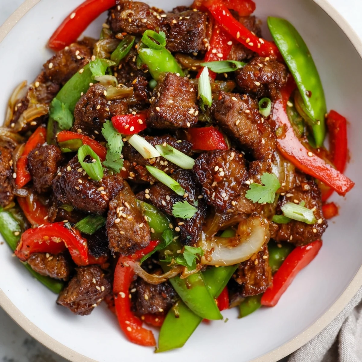 Asian-inspired cube steak glistening with soy ginger glaze alongside crisp colorful stir-fried vegetables