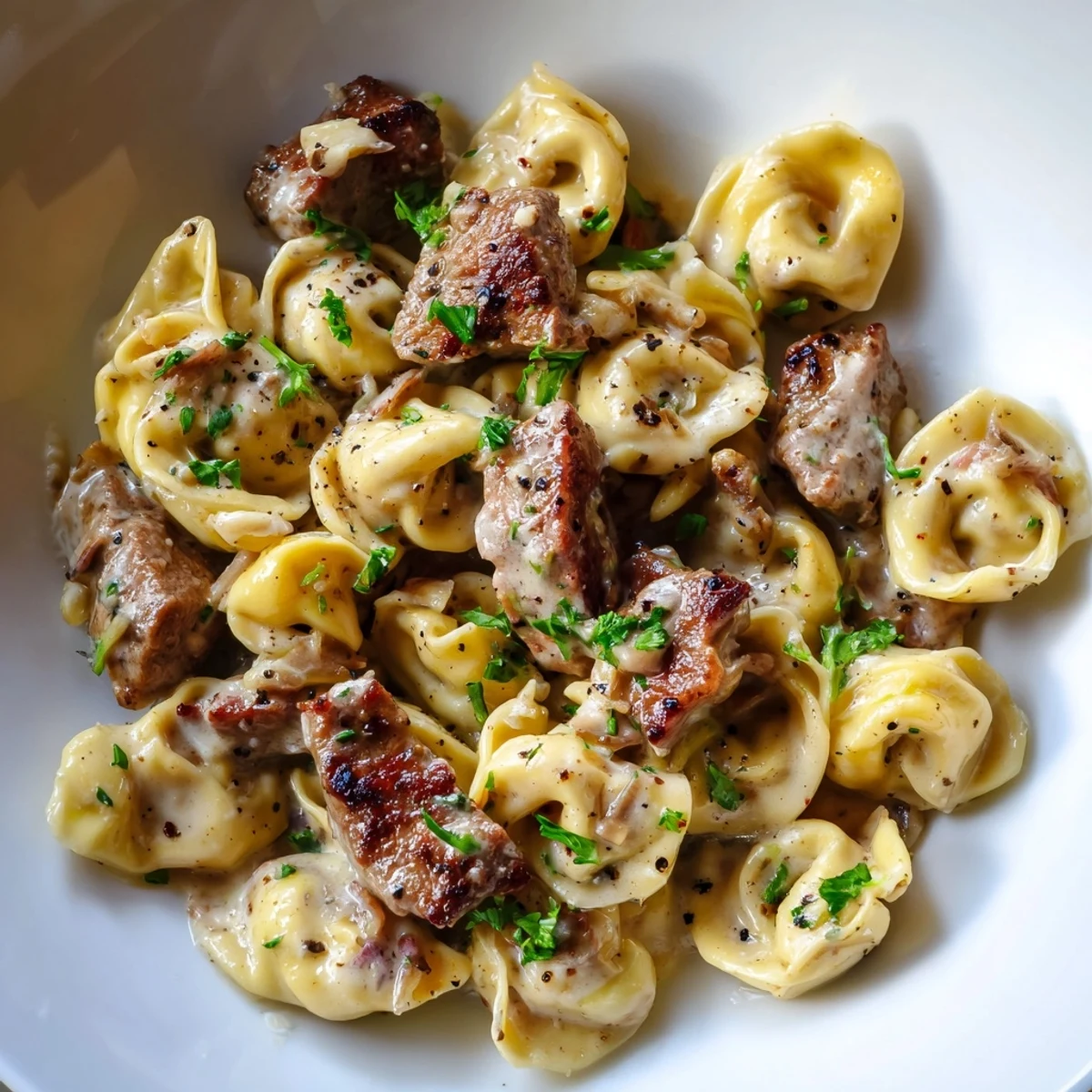 Hearty garlic steak tortellini in a silky cream sauce topped with seared sirloin pieces
