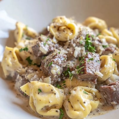 Sizzling steak bites nestled into cheesy garlic steak tortellini with rich cream sauce